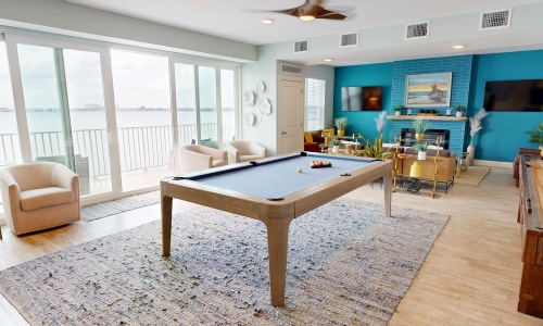 lounge with billiards table chairs and couch 