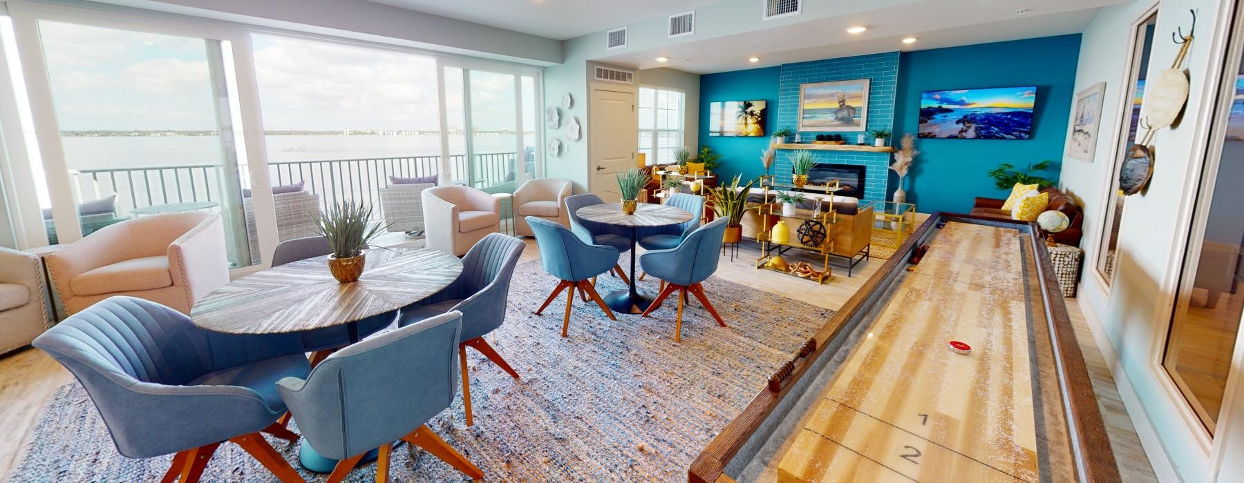 a room with a table chairs and a fan