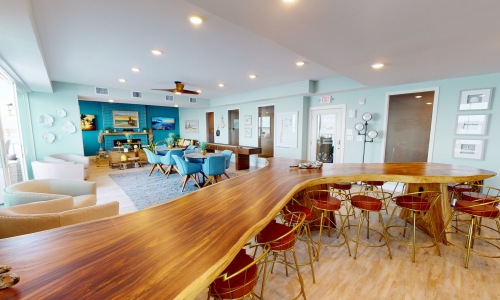 a clubroom with a large table and chairs