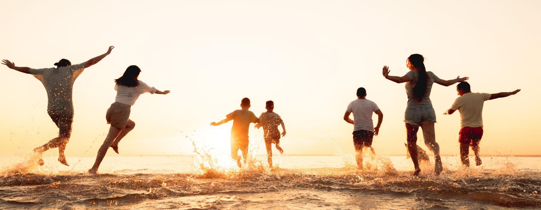a group of people jumping into the water