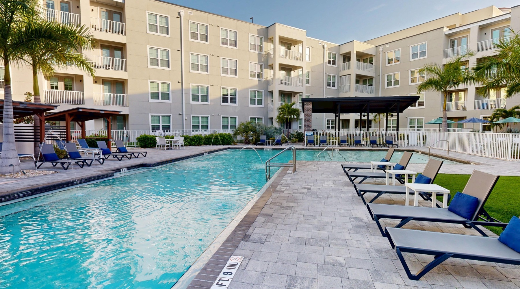 pool in a courtyard with lounge seating