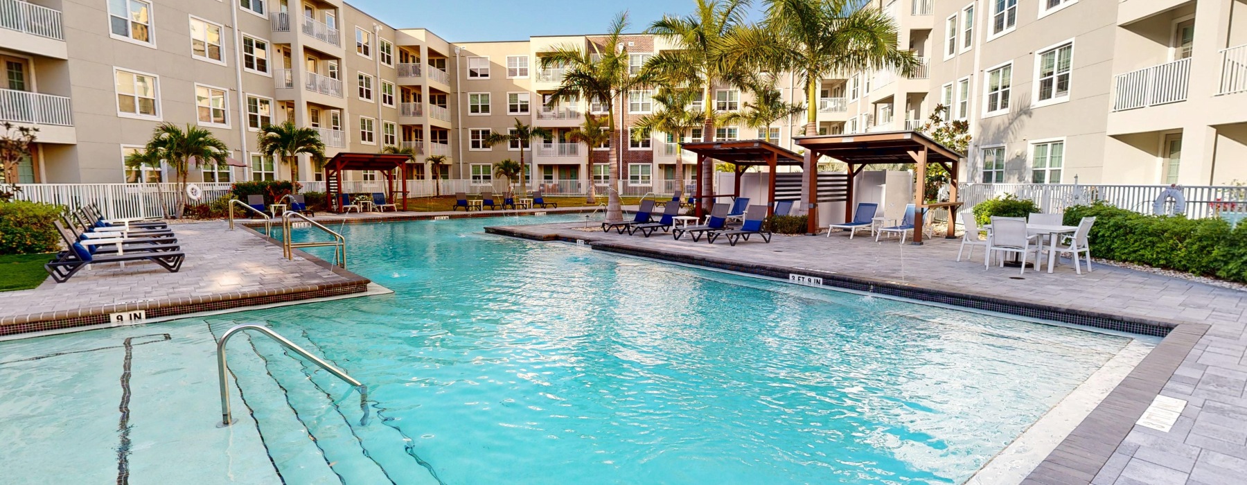 a swimming pool with lounge chairs
