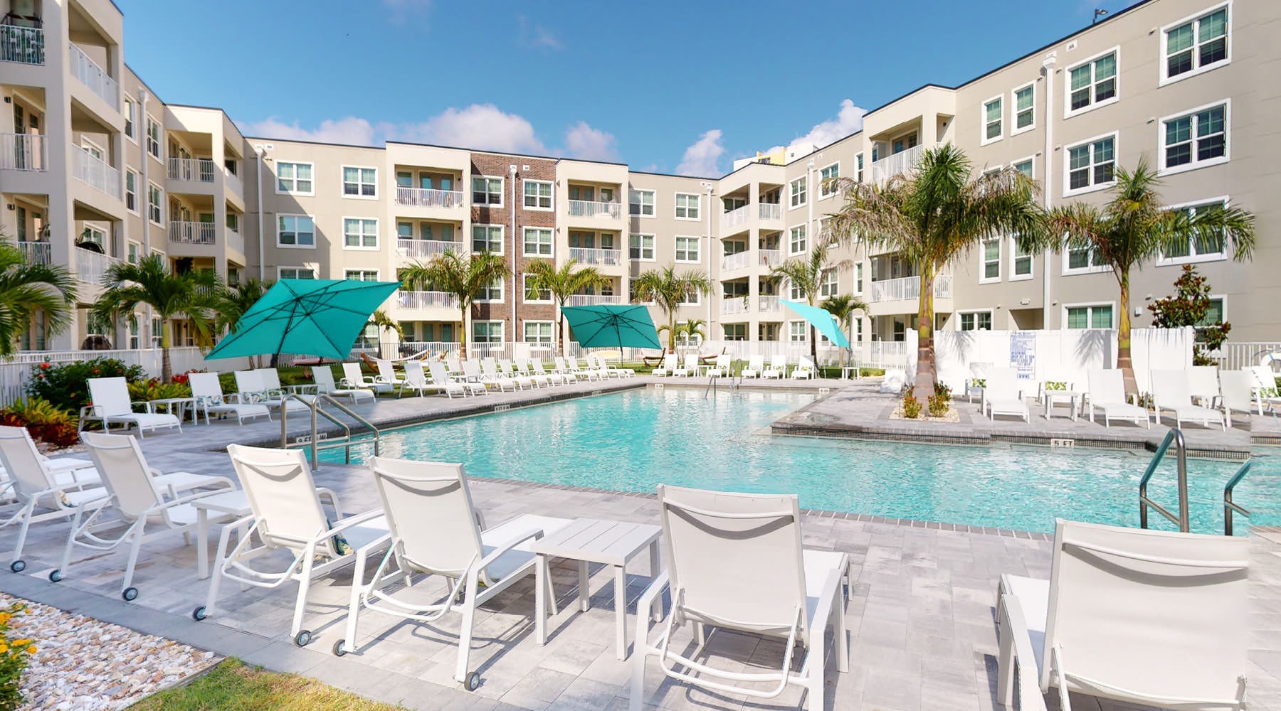 pool in a courtyard with lounge seating